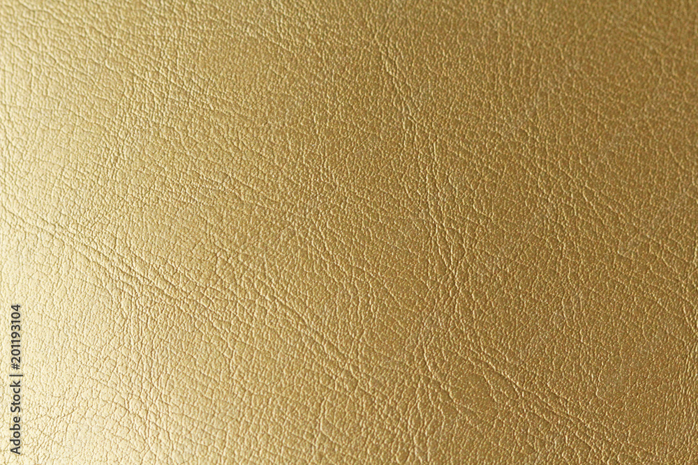 Gold or Bronze Natural Leather Background. Shiny yellow leaf gold foil