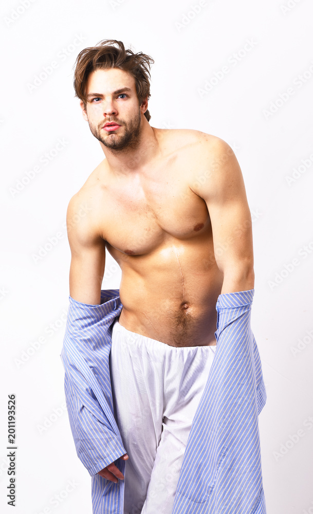 Muscular guy with torso takes off blue bathrobe.
