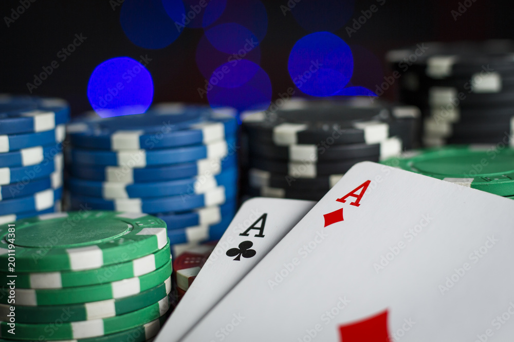 Obraz premium A lot of poker chips with a pair of aces on the table