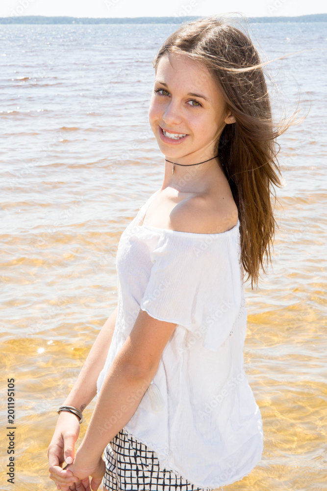 Outdoor summer portrait of young pretty girl to the ocean at tropical beach enjoy freedom and fresh air