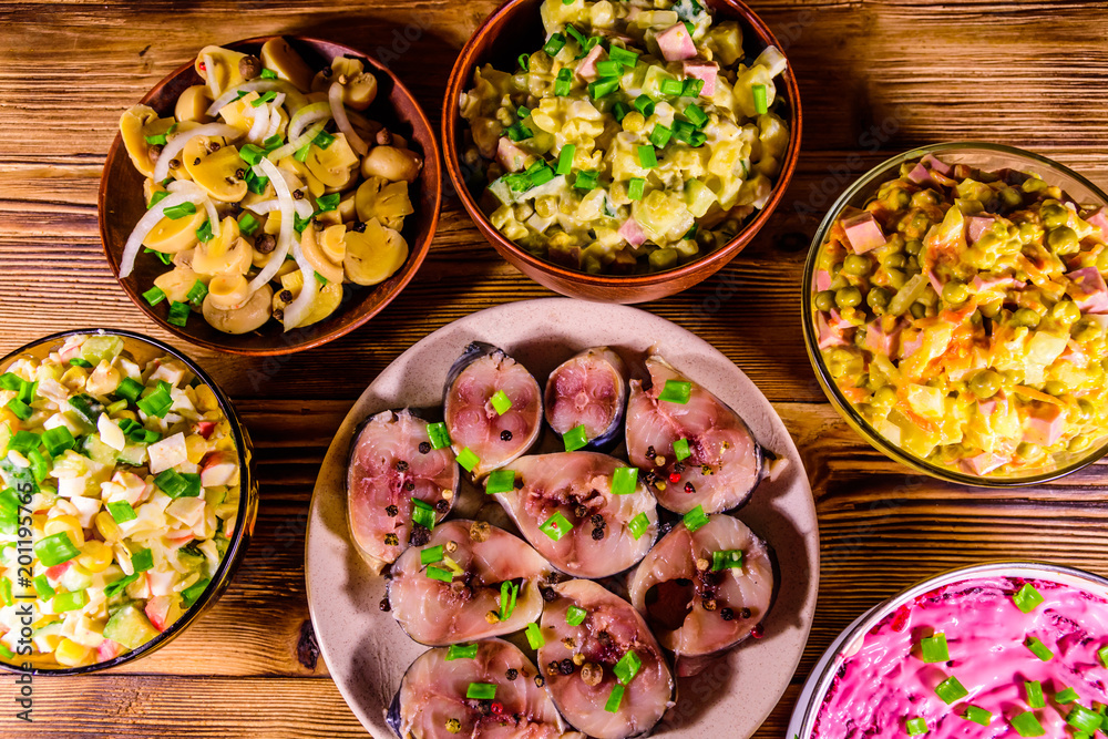 Different festive dishes on a wooden table. Top view Different festive dishes on a wooden table. Top view