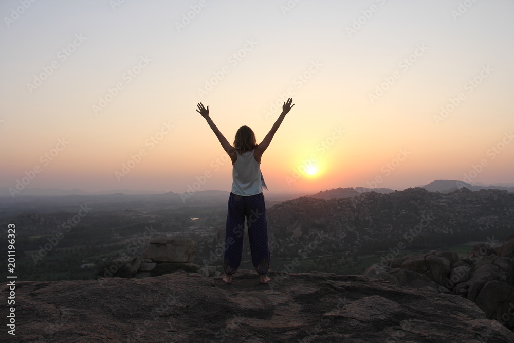 The girl at sunset. The girl stands with her back on the top of the ...