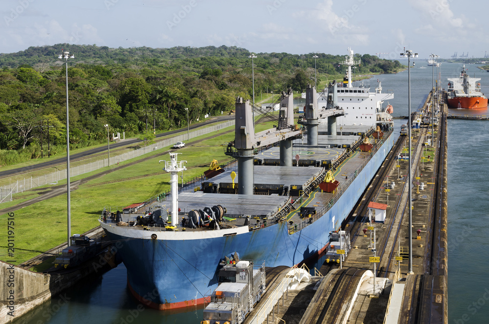 Merchant ships pass the locks of the Panama Canal.