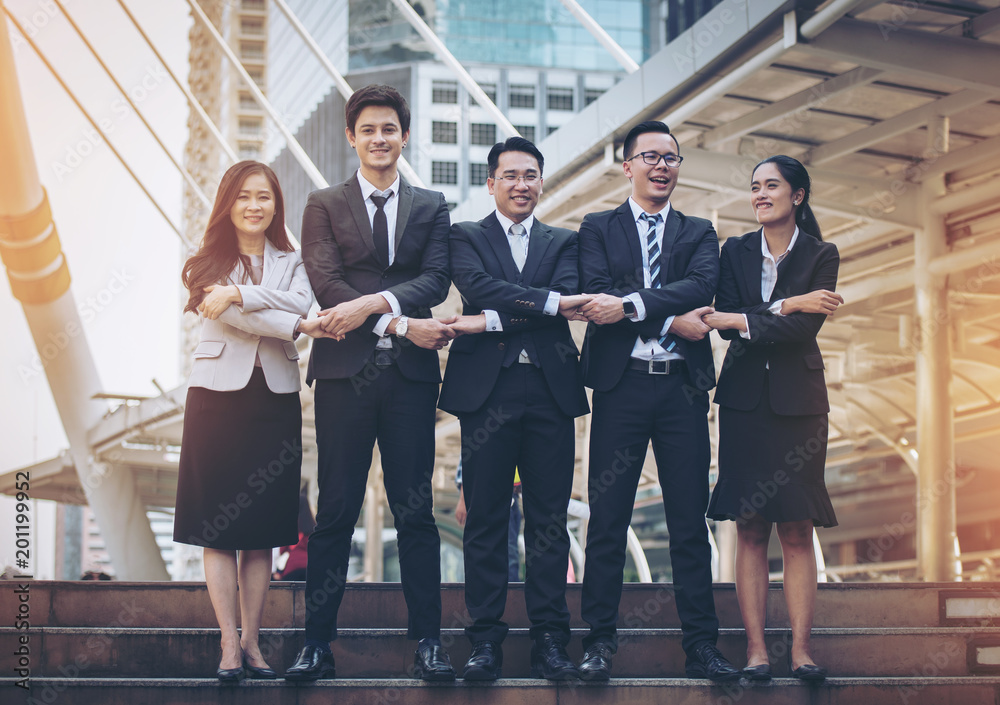 Fototapeta premium Business team up and holding hands on the ladder.