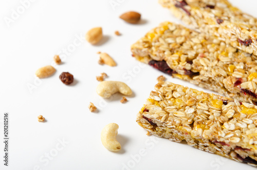 Energy bar of muesli with nuts, berries and oat flakes on white background. Healthy food, granola for breakfast. Diet