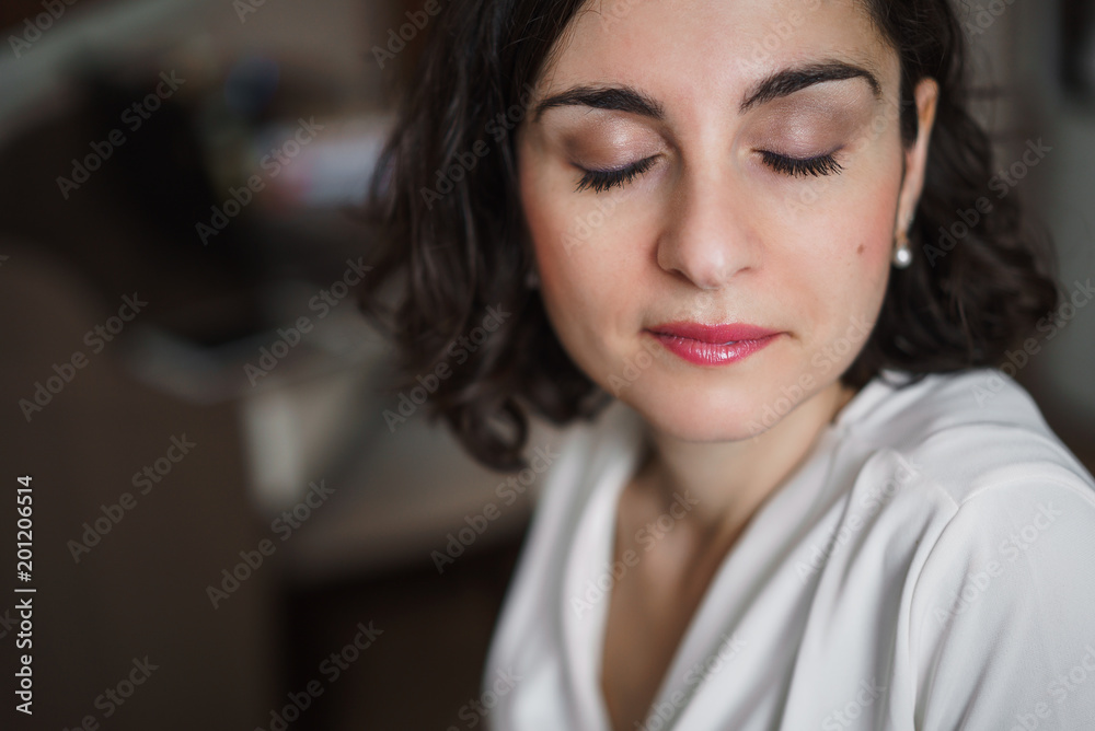 Young smiling brunette woman with curly hair with eyes closed. Close up. Young smiling brunette woman with curly hair with eyes closed. Close up.