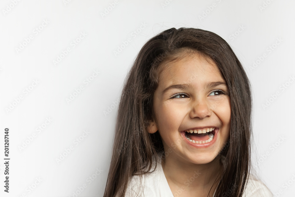 Portrait of happy smiling brunette child girl with long hear isolated on white background. Place for text. Portrait of happy smiling brunette child girl with long hear isolated on white background. Place for text.
