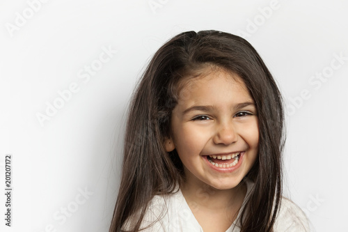 Portrait of happy cute brunette child girl with long hear. 