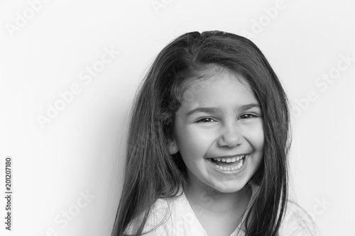 Portrait of happy child girl. Black and white portrait. © kaganskaya115