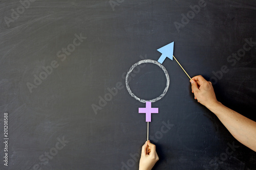 Male and female gender symbols on a black background