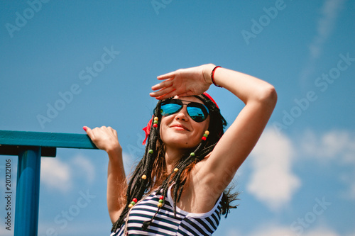 girl striped dress sunglasses smile looks sky hand