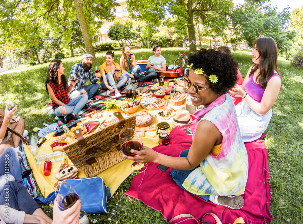 Fototapeta premium Happy friends doing picnic in public park outdoor