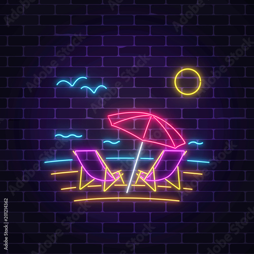 Glowing neon summer sign with chaise lounges, beach umbrella, ocean and gulls on dark brick wall background.
