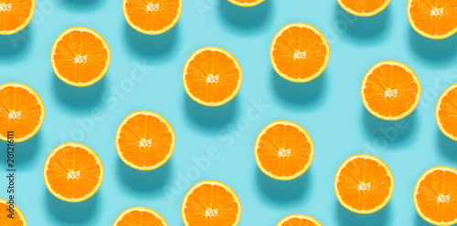 Canvastavla Fresh orange halves on a blue background