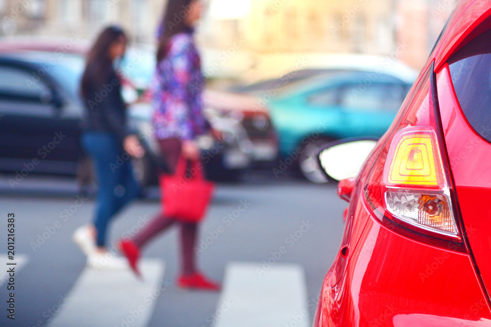 Pedestrians walk along a crosswalk in a lunch hour. Peak hour.. Pedestrians walk along a crosswalk in a lunch hour. Peak hour..
