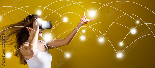 Network and connection technology concept with young woman using a virtual reality headset