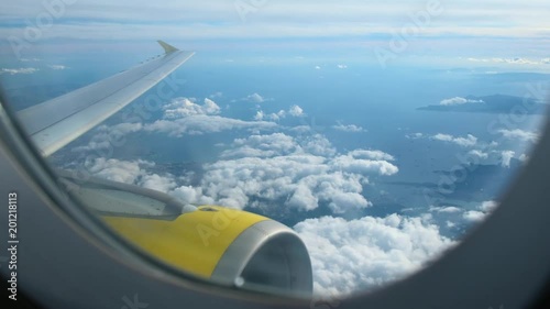 Airplane flying in the sky, clouds and beautiful sunshine.