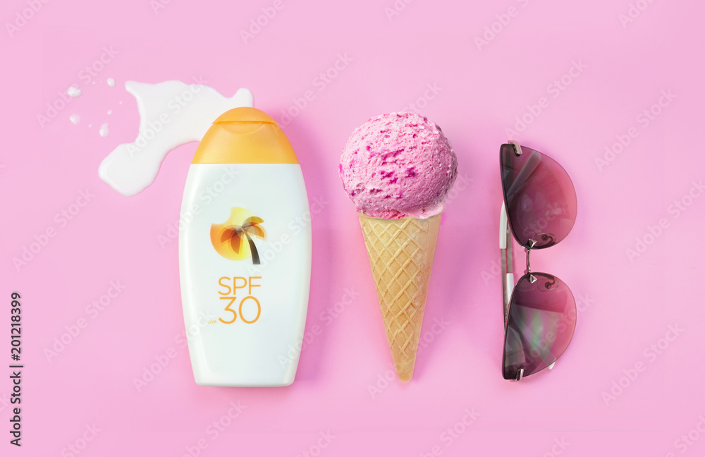 Creative layout concept for summer holidays. A set of sunglasses, ice cream cone and bottles of lotion against sunburn on a pink background. Creative layout concept for summer holidays. A set of sunglasses, ice cream cone and bottles of lotion against sunburn on a pink background.