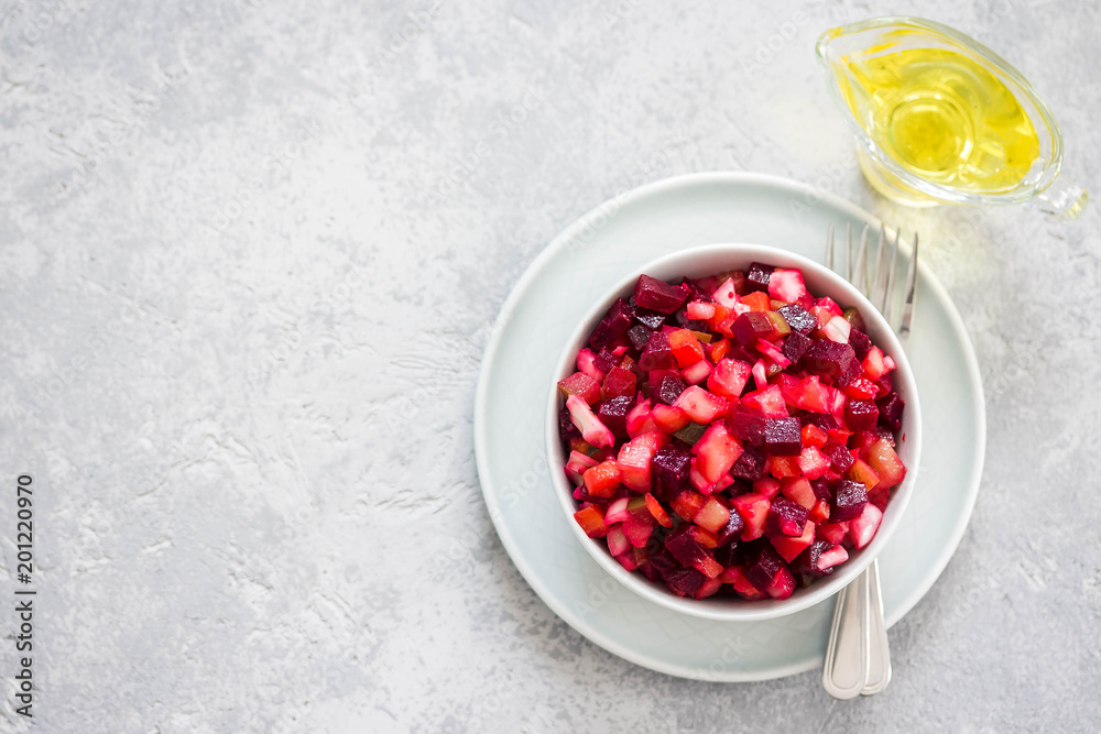 Fresh beetroot salad in a bowl on light concrete background. Top view, copy space. Fresh beetroot salad in a bowl on light concrete background. Top view, copy space.