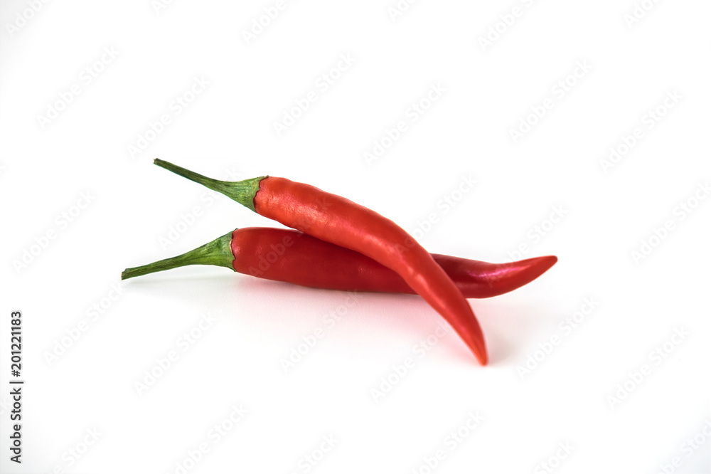 Two red hot chili pepper isolated on the white background. Selective focus.
