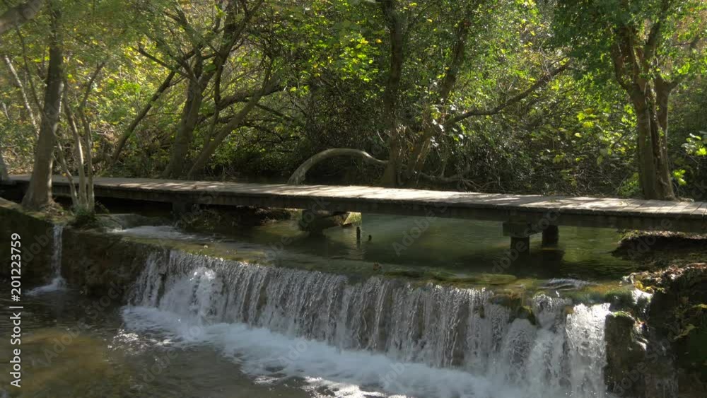 River flowing under a wooden bridge River flowing under a wooden bridge