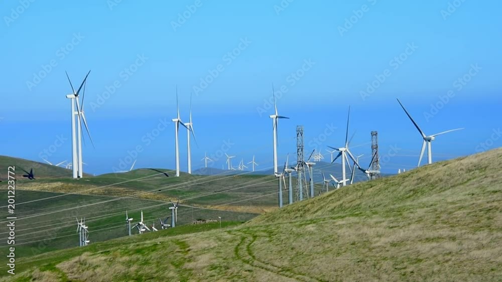 Lazy windmills in the coastal hills in central California. Camera locked. Lazy windmills in the coastal hills in central California. Camera locked.