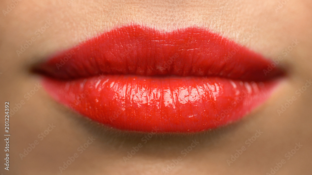 beauty, make up and people concept - close up of woman lips or mouth with red lipstick beauty, make up and people concept - close up of woman lips or mouth with red lipstick