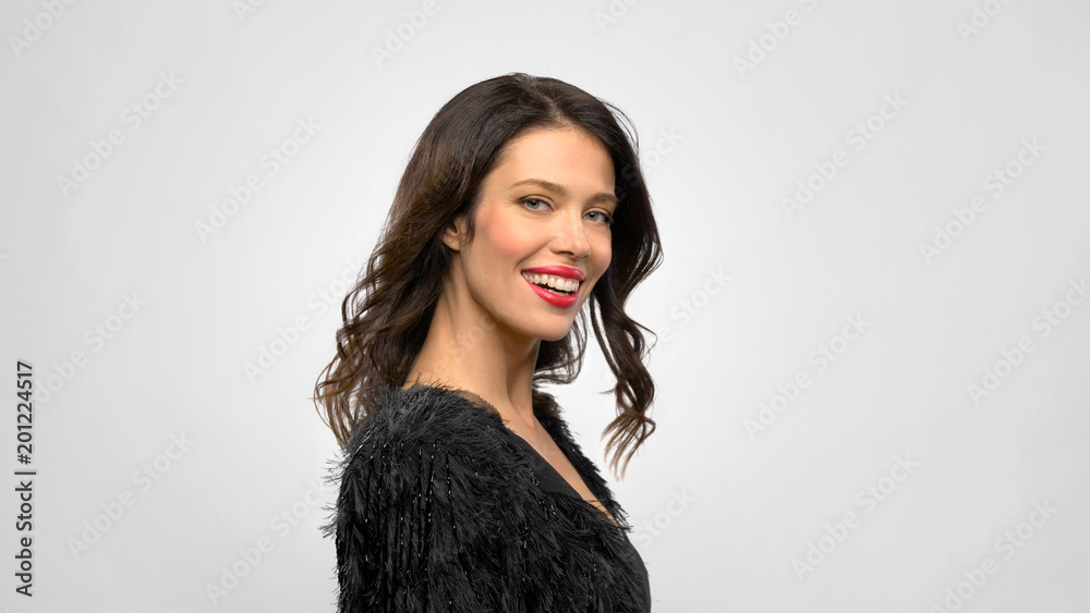 fashion, style and people concept - happy smiling beautiful young woman in black party dress