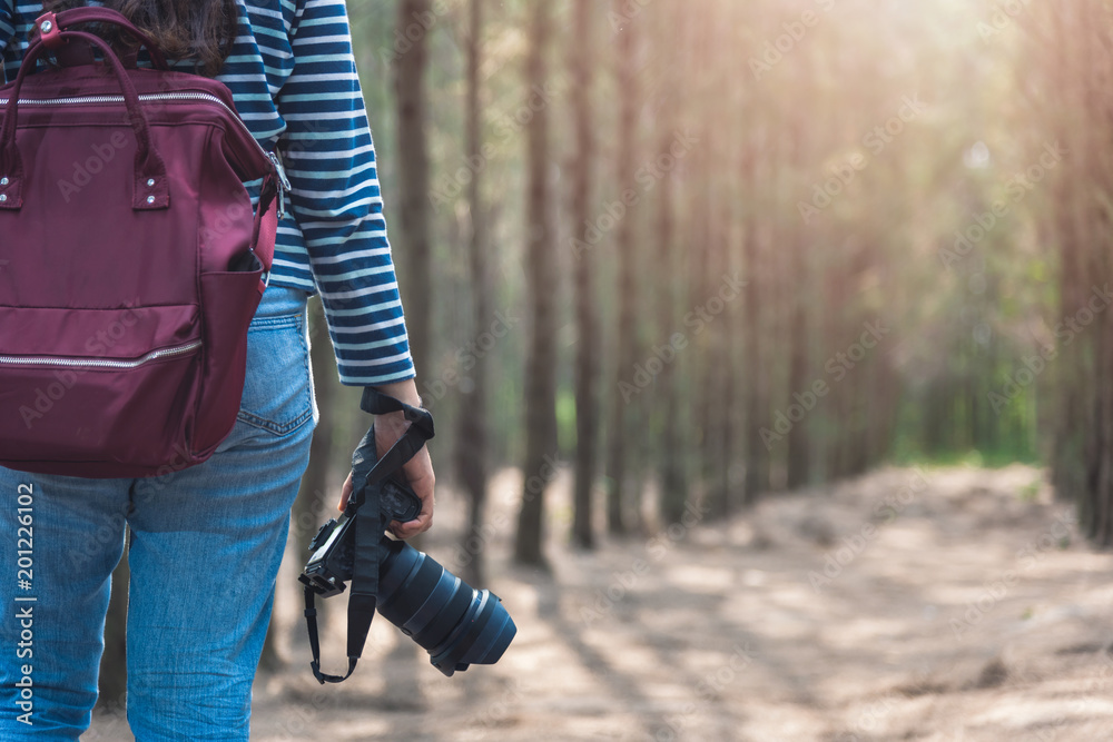 Fototapeta premium Young woman lifestyle using DSLR camera photographer travel taking photo