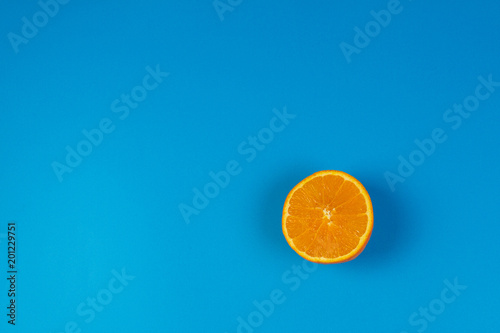 Ripe orange cut in half on blue background  top view