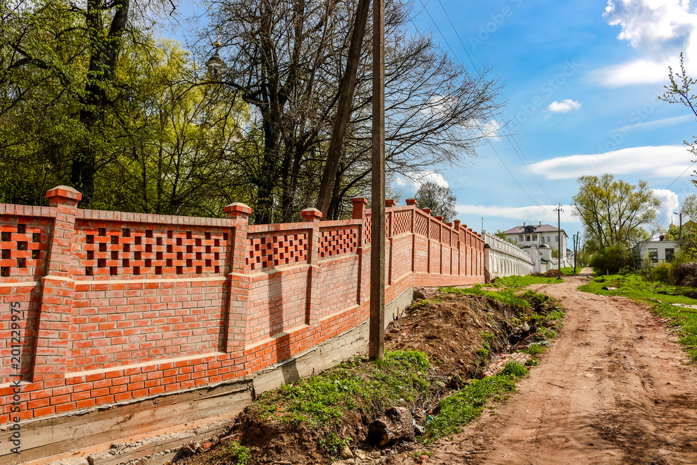MALOYAROSLAVETS, RUSSIA - MAY 2016: Territory of the Svyato-Nikolskiy Chernoostrovskiy convent monastery in Maloyaroslavets. Fence