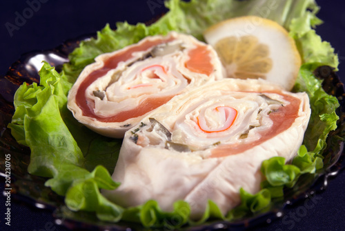 Sandwiches with salmon on leaves of green salad and lemon