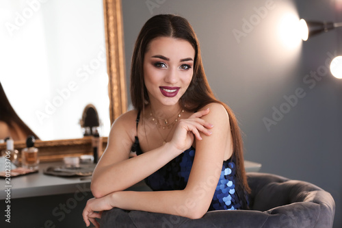 Portrait of beautiful woman with bright makeup indoors