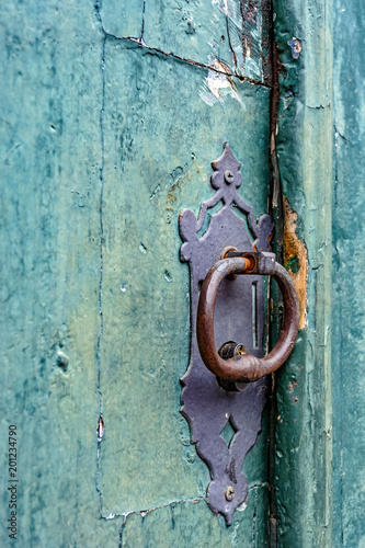 Old and aged historic church door in blue-green wood in the city of Ouro Preto, Minas Gerais with a stone frame