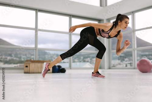 female in a stretching pose at fitness studio