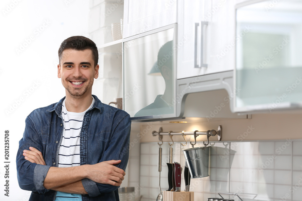 Portrait of handsome young man in kitchen