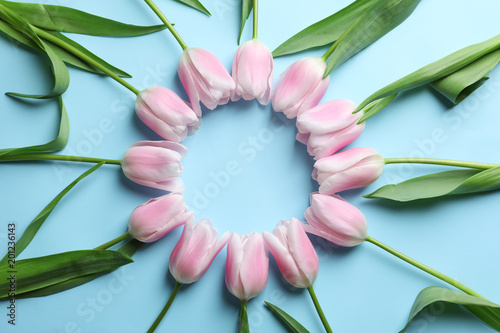 Fototapeta Naklejka Na Ścianę i Meble -  Beautiful frame made of tulips for Mother's Day on color background