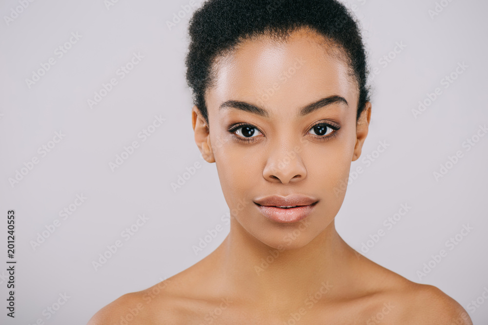 beautiful young woman with perfect skin looking at camera on grey beautiful young woman with perfect skin looking at camera on grey