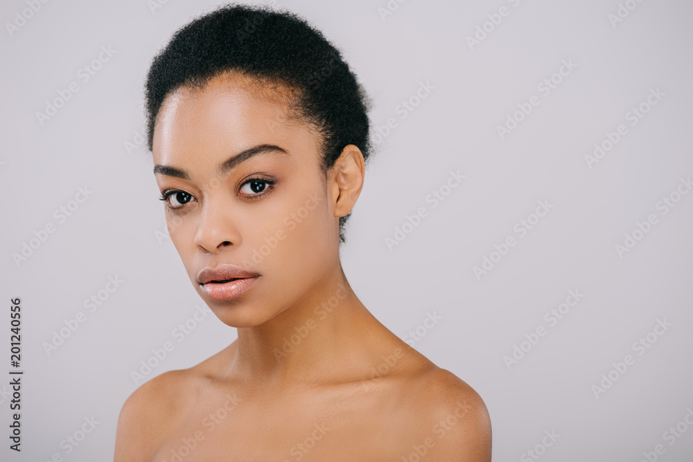 attractive young woman with perfect skin looking at camera isolated on grey attractive young woman with perfect skin looking at camera isolated on grey