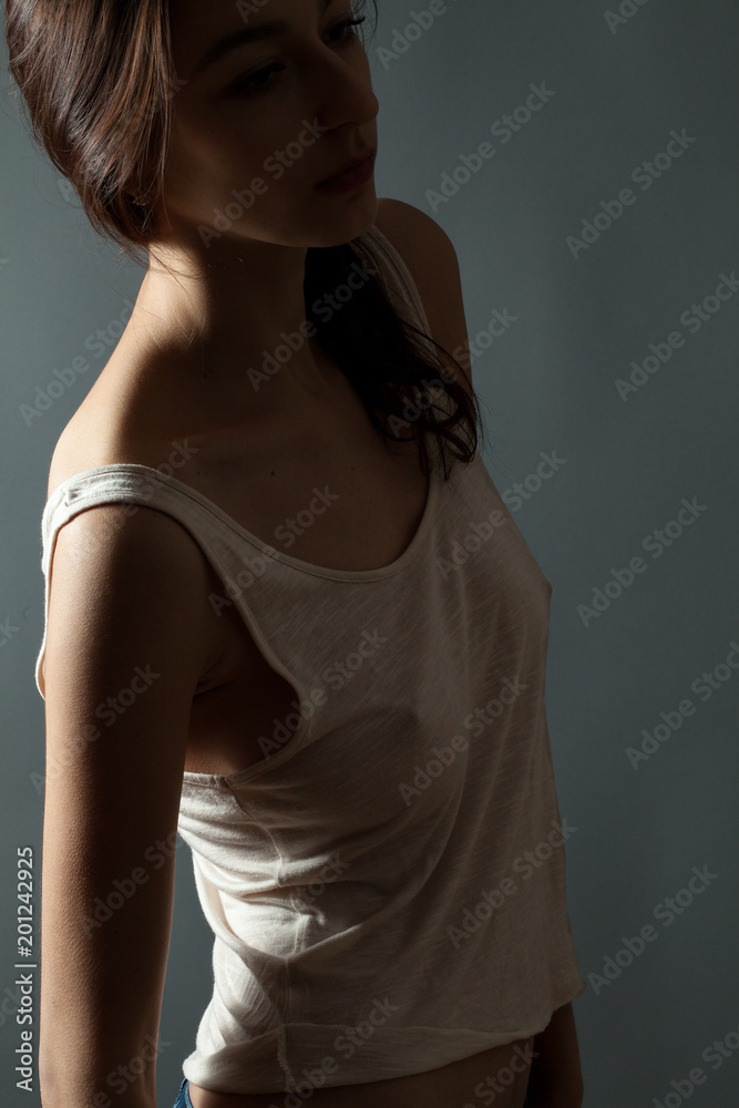 Naklejka premium Attractive thin young woman in studio. Low key