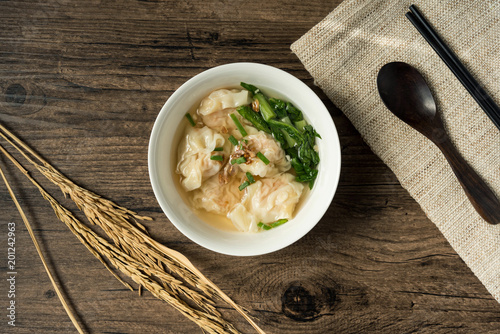 Shrimp wonton with braised pork in soup on wooden table - Asian food style  / Select focus image