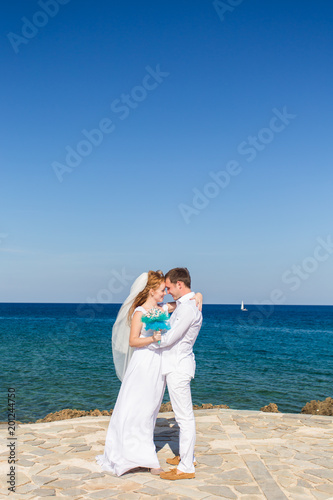 Happy wedding couple on sea beach