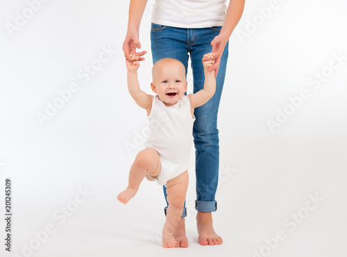 First steps. Little baby girl learning to walk