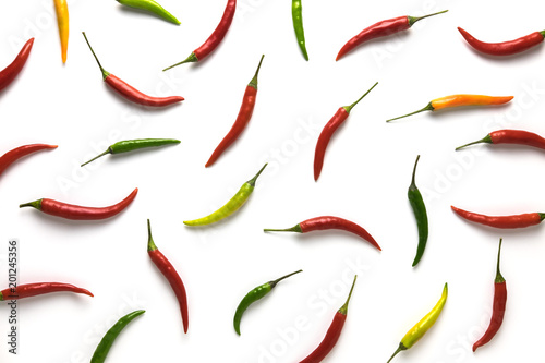 Red, green and yellow hot little chili peppers pattern on white background. Top view. Flat lay.