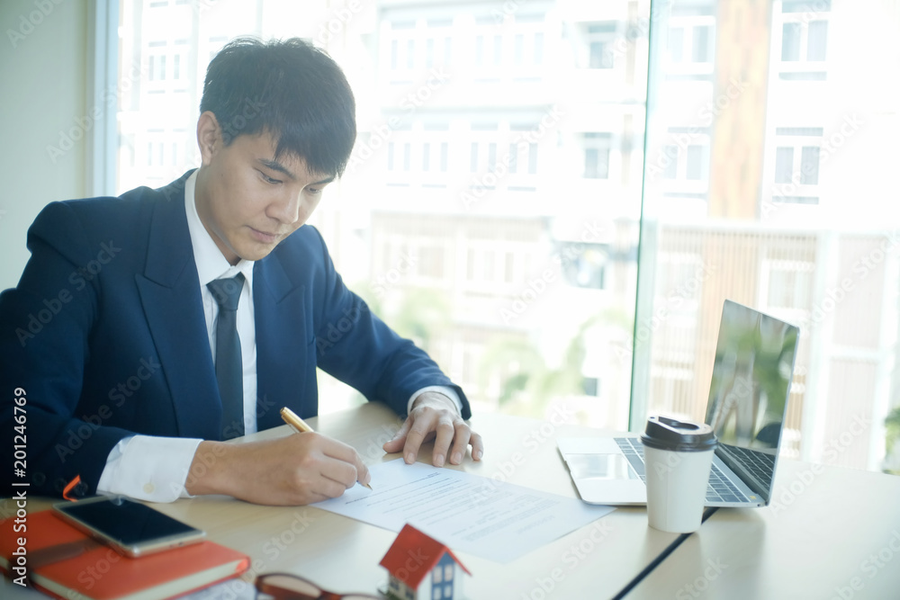 House agent working with paper document on office table. House agent working with paper document on office table.