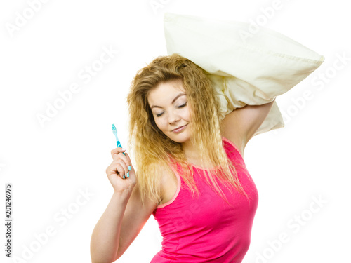 Sleepy woman hugging white pillow