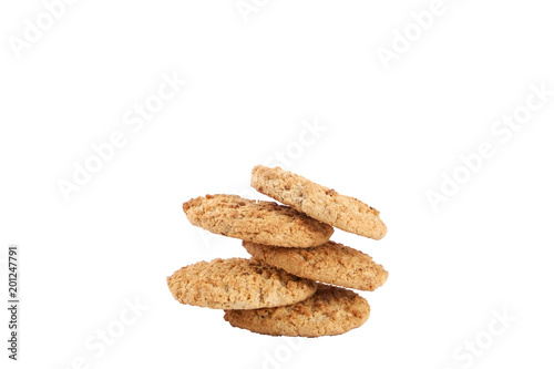Stack of healthy vegan integral cookies made of hazelnut powder & linseed isolated on white background. Home made vegetarian sugarless & gluten free snack with nuts. Close up, copy space, top view.