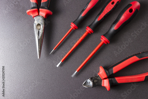 Obraz na płótnie Tools electrician screwdrivers, pliers, platypuses on a black background. w salonie