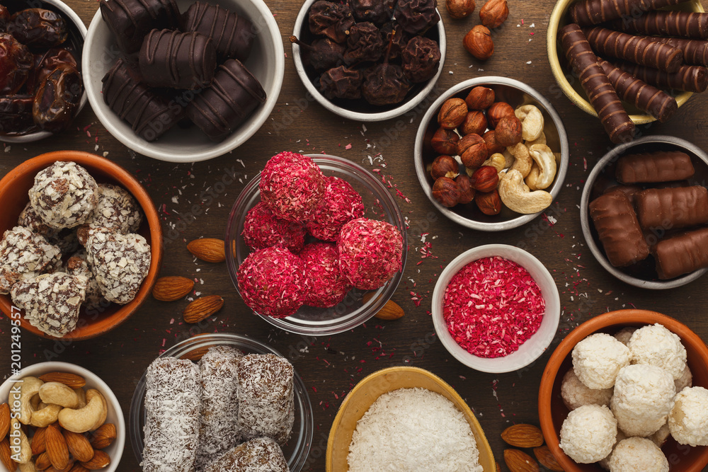 Wooden desktop with assortment of healthy sweets and nuts