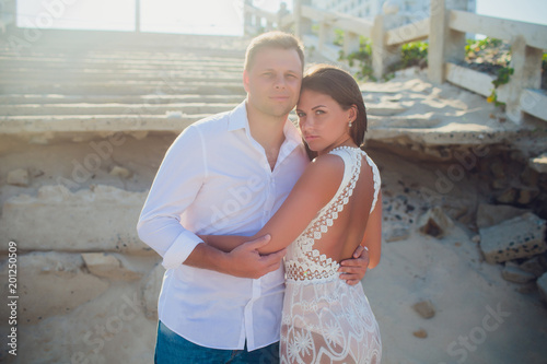 couple photographed on vacation sea, ocean. Against background destroyed Vietnamese staircase photo